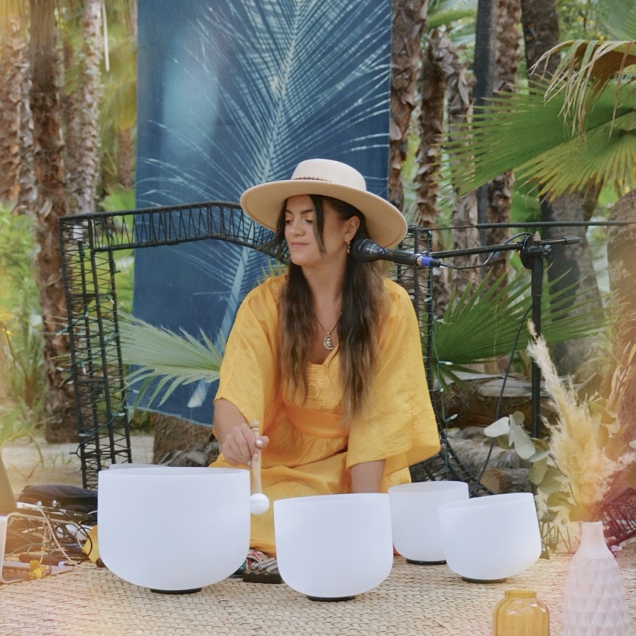Marsseia playing crystal bowls in a jungle garden